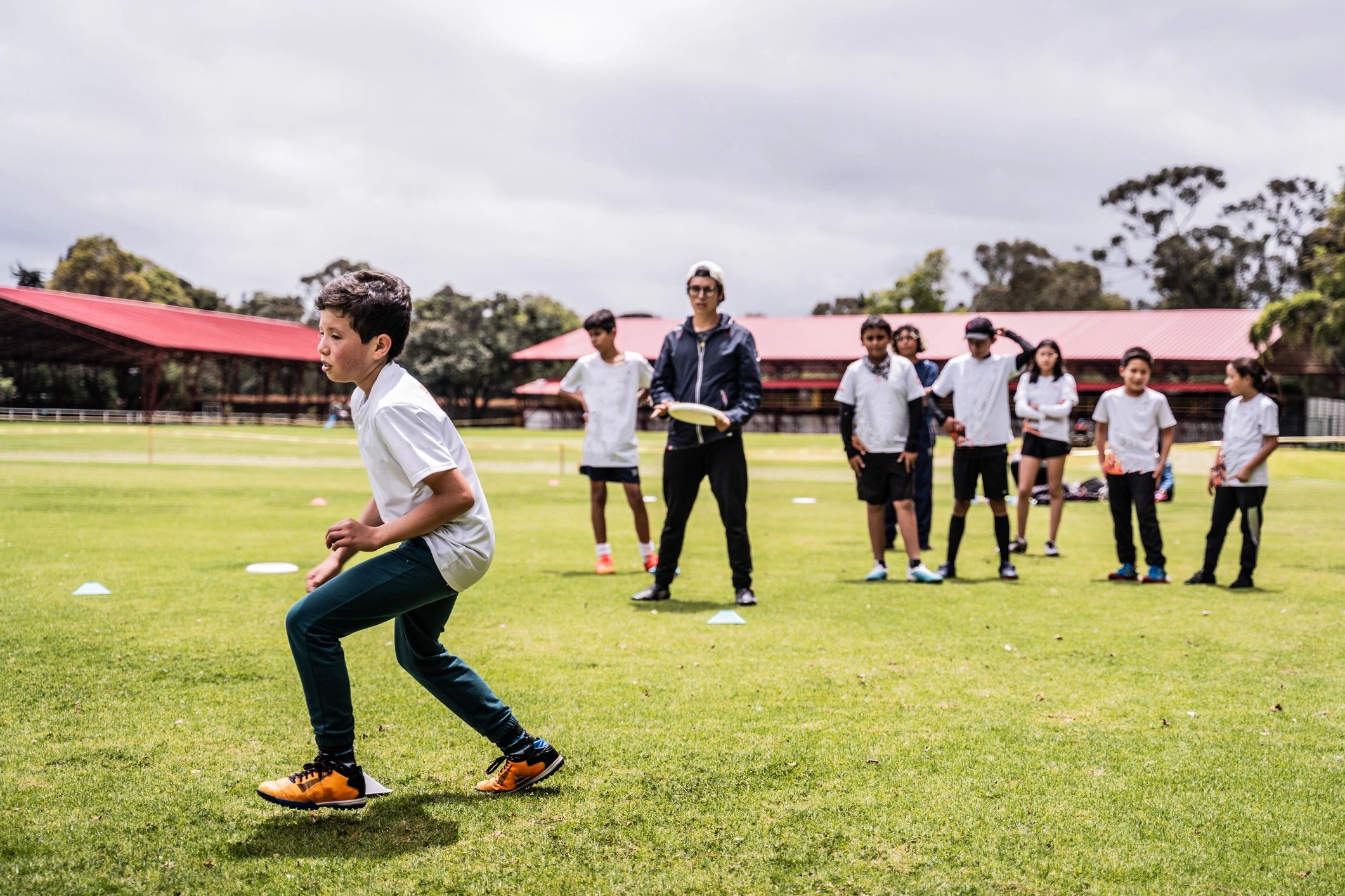 Coach instructing students during sports practice