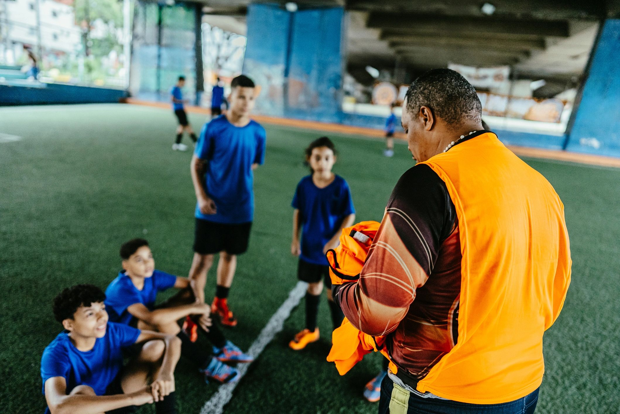 Soccer coach leading players on the field