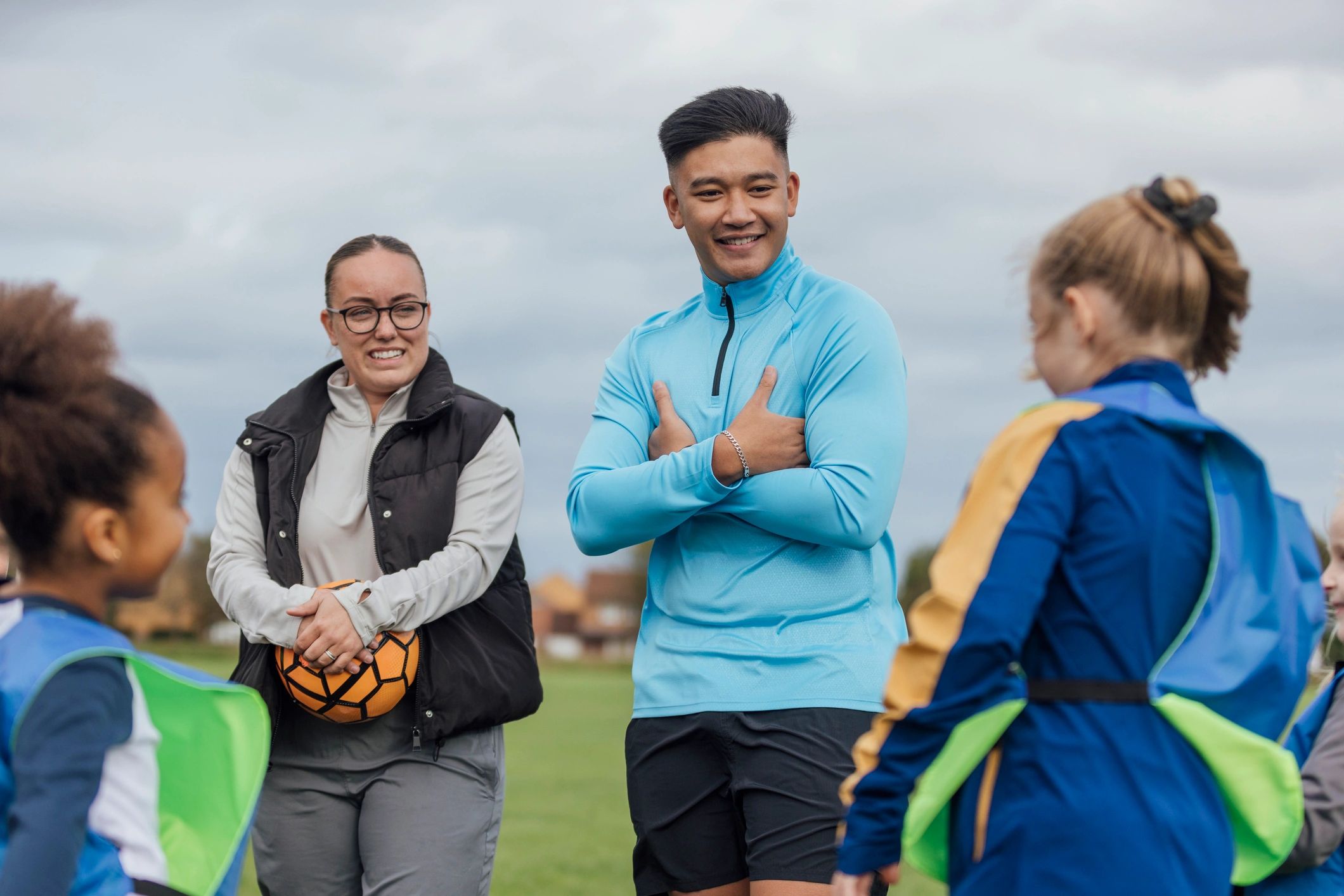 Youth soccer coaches speaking with players during training