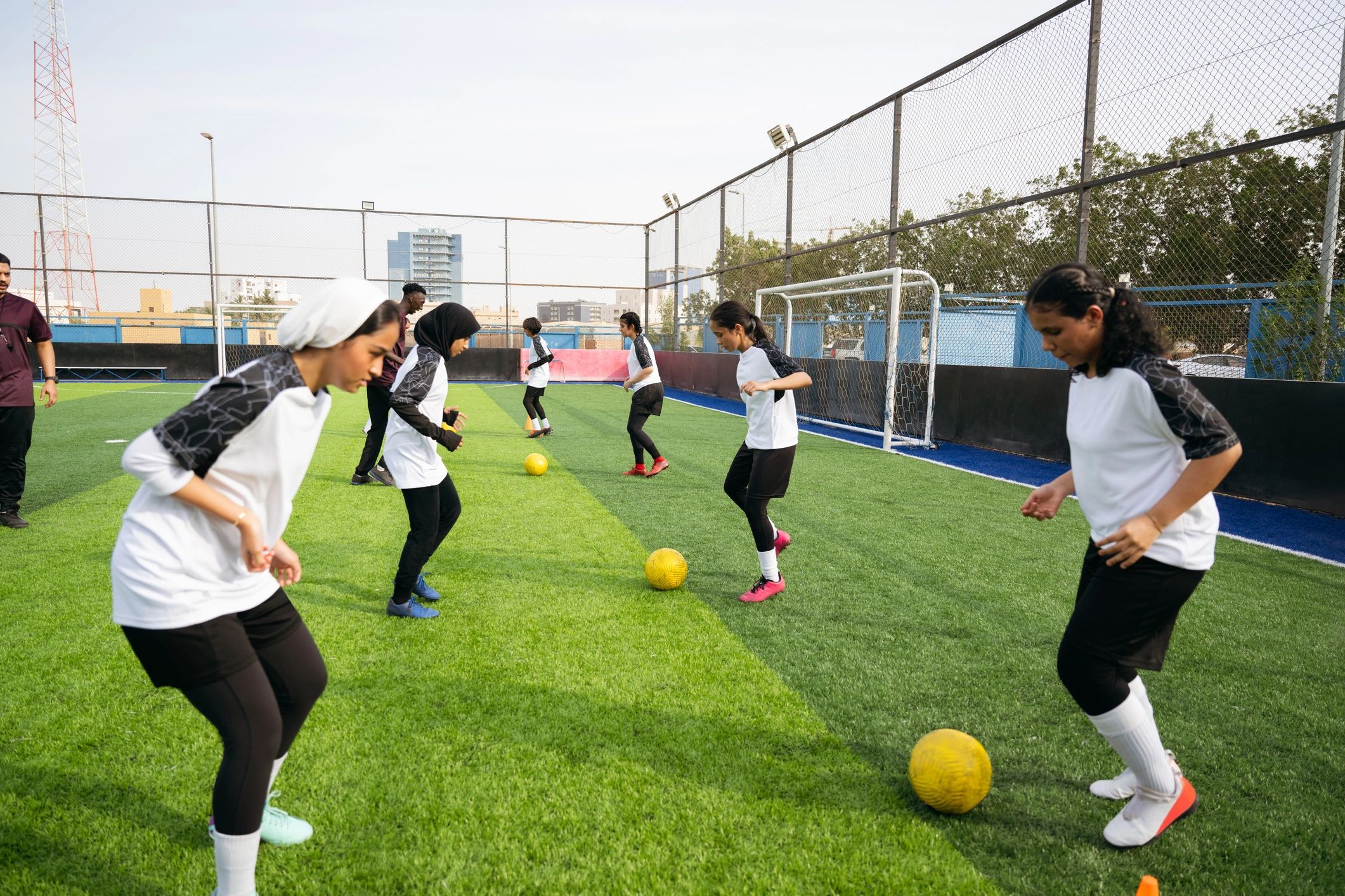 Teen soccer players practicing passing drills