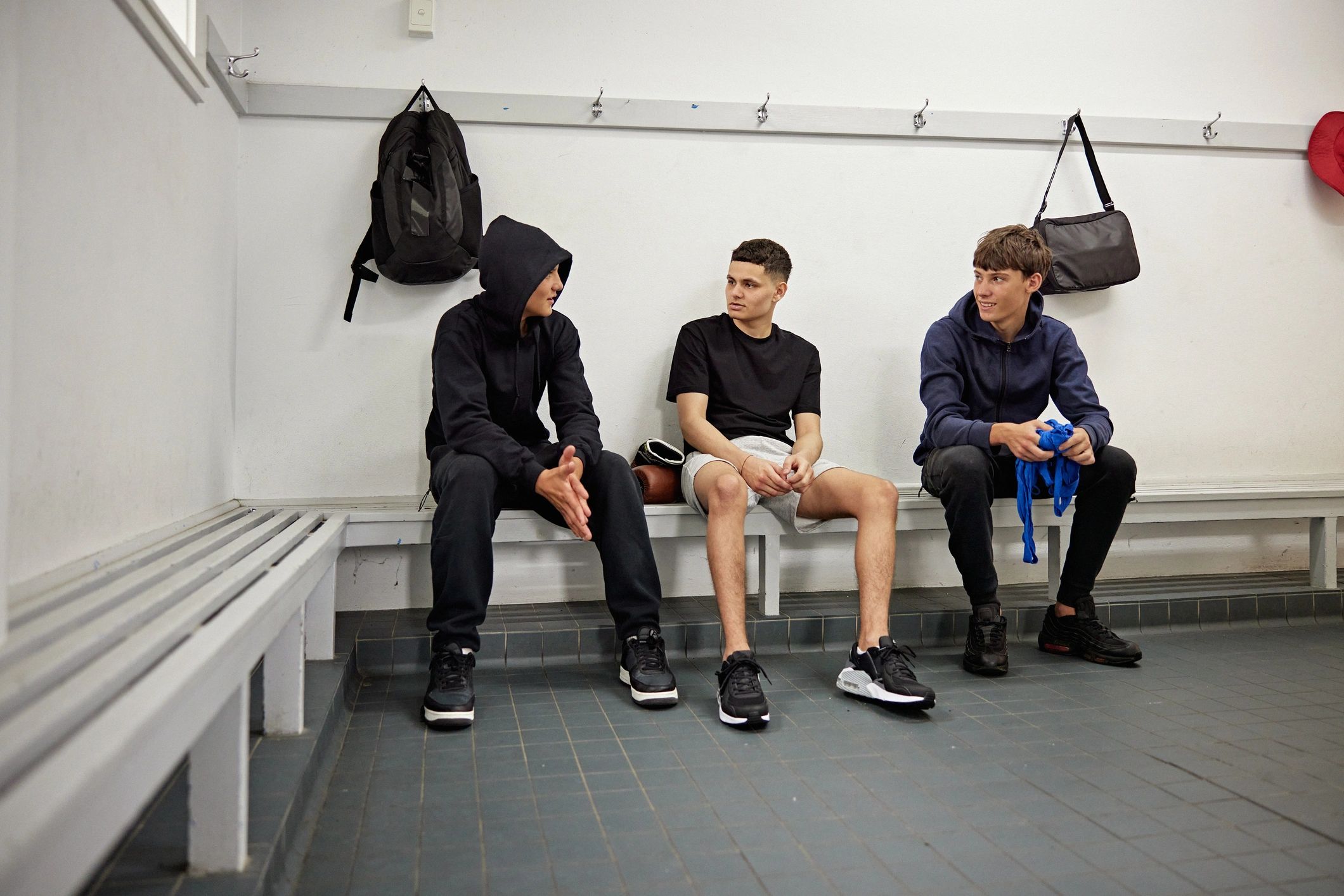 Youth athletes talking together before training